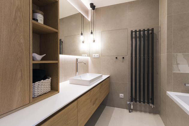 Také v obou koupelnách designér vyzrál na původní developerské vybavení a nenarušil minimalistickou, ale i útulnou koncepční linku celého bytu