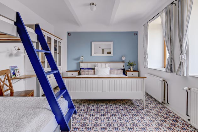 Prostorově velkorys&yacute; apartm&aacute;n je charakteristick&yacute; romantickou atmosf&eacute;rou a&nbsp;syt&yacute;mi detaily v&nbsp;modr&eacute; a&nbsp;červen&eacute;